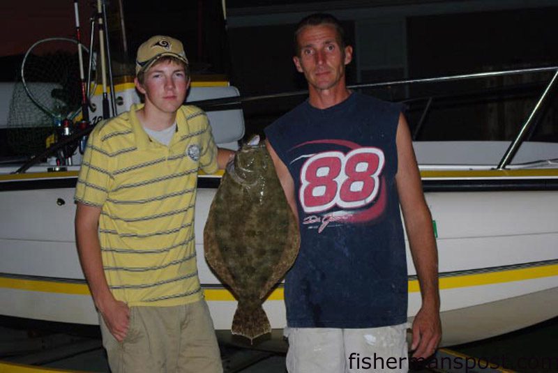 Zachary and James Myers with a 3 lb., 22" flounder that Zachary hooked in Snows Cut on a live finger mullet.