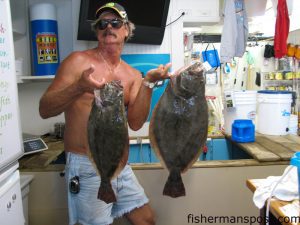Dwight Kinton, of Morehead City, with a pair of large flounder (the biggest 11 lbs.) he hooked on live finger mullet while fishing inshore near Morehead City. Weighed in at Chasin Tails Outdoors.