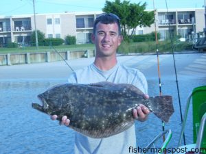 Luke Donat with a 6.18 lb. flounder he hooked at the Masonboro jetties on a live bait.