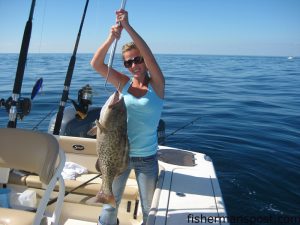 Holly Wise, of Wilmington, with a gag grouper that fell for a dead mullet in 70' of water 18 miles off Holden Beach while she was fishing with her fiance John.
