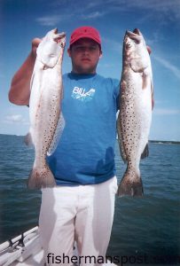 Mike Martin, from Belmont, NC, with a couple of speckled trout caught near Bald Head Island using live mullet minnows. He was fishing with Capt. Greer Hughes of Cool Runnings Charters out of Southport.