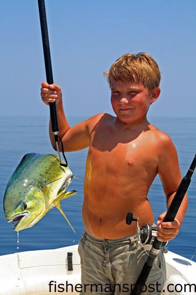 Cody Banks (age 11) with a dolphin he caught on a slow-trolled pogy near Frying Pan Tower while fishing on the "Wild Rice."