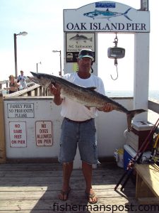 Mike Long, of Oak Island, with a 24.3 lb. king mackerel he hooked on a live bluefish from Oak Island Pier.