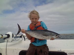 Carter Lewis, of Morehead City, with a false albacore he hooked off Shackleford Banks on a soft plastic bait.