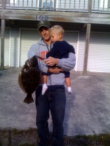 Jason R. Harris and Fint S. Harris (age 2) with a 20.5" flounder Jason hooked on a live shrimp pinned to a Carolina rig near the Surf City Bridge.