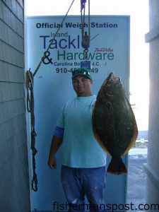 Wes Barbour, of Island Tackle and Hardware, with a 12 lb., 14 oz. flounder he hooked on a live finger mullet at some nearshore structure off Carolina Beach.
