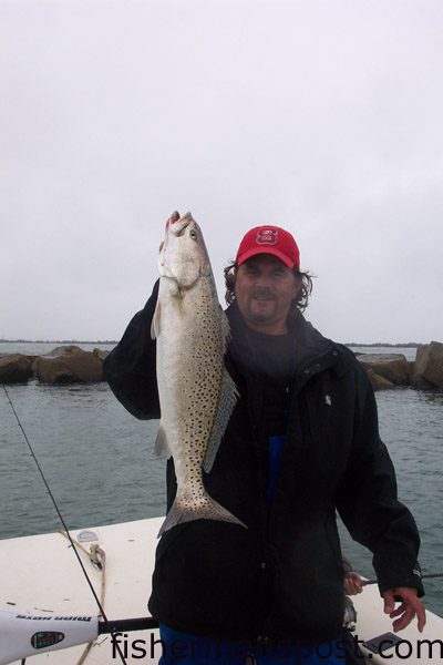 Todd Byrd, of the Triangle Lounge in Wilmington, with a 26", 6 lb. speckled trout he hooked on a live, Carolina-rigged finger mullet at the Masonboro Jetties while fishing with Rodney Yohe.