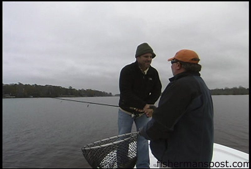 Gary Hurley, of Fisherman's Post Newspaper, gets assistance from Capt. Gary Dubiel, of Spec Fever Guide Service, with handling Gary's first topwater striper of the day. The fish came off a blind cast in the Trent River.