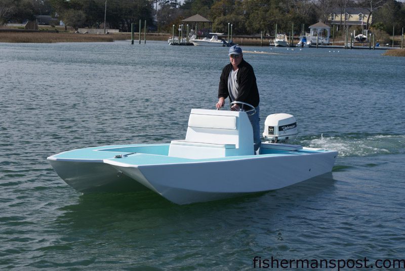 Scott Marles at the helm of M & M Marine's Invert flats boat, displaying the craft's unique inverted-V hull.
