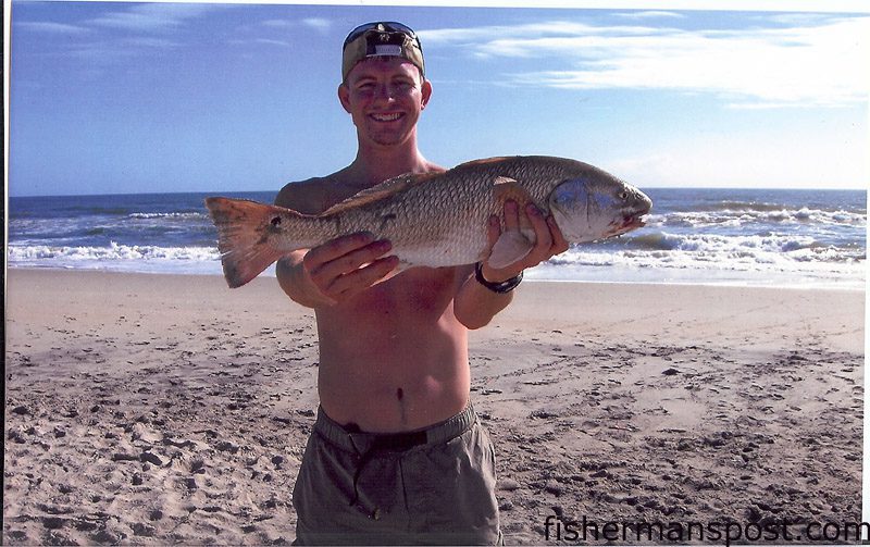 Mark Smith, from Wilmington, with a red drum caught on cut mullet while fishing the Cape Lookout surf. He was fishing with his father, Richard Smith, and a Boy Scout troop from Fayetteville.