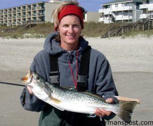 Susan Chapman, of Atlantic Beach, with a big speckled trout she hooked on a MirrOlure while fishing a slough in the AB surf with her husband Jerry.