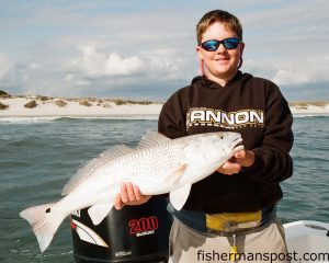 Crockett Henderson, of Cape Carteret's "Liquid Fire" fishing team, with a 30" red drum he hooked and released along the breakers near Bogue Inlet on a  swim shad.