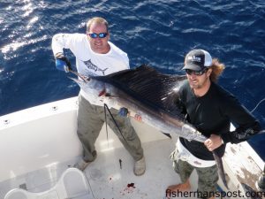 Pat Horning and Phil Luther with Phil's first sailfish. The sail fell for a ballyhoo under a blue/white Ilander near the Steeples while they were fishing on the "Salty Seaman" with capt. Paul Horning.
