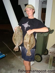 Katie Barrier, from Salisbury, NC, with a pair of flounder she hooked from the beach at Fort Fisher while fishing with her husband Tim.