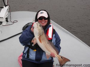 Hannay Young, of Belmont, NC, with a 31", 15 lb. red drum she hooked on a swimbait in Buzzard's Bay while fishing with Capt. Robert Schoonmaker of Carolina Explorer Charters out of Carolina Beach.