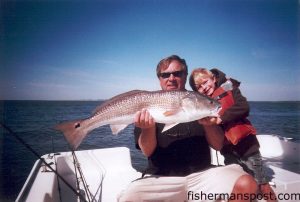 Ray and Cheney Boggs, from Soutport, with an over-slot red drum they hooked on a live finger mullet near Bald Head Island. they were fishing with Capt. Greer Hughes of Cool Runnings Charters.