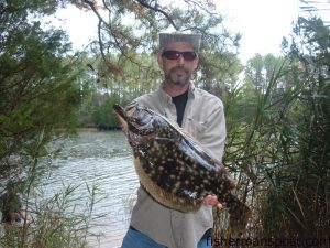 Jason Armstrong, of Southport, with a 23" flounder he hooked in Wildlife Creek on a Gulp Shrimp.