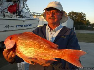 Jim Foreman, of King, NC, with a red snapper he hooked on a whole squid at some structure in 100' east of Frying Pan Shoals while fishing on the "Bottom Scratcher."