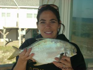 Jennifer Poage, from Wilmington, with a citation 2.5 lb. pompano that fell for a fresh shrimp bait in the Oak Island surf.