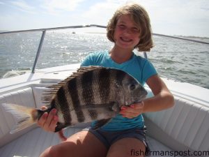 Christina Sports with her first saltwater fish, a 21" sheepshead she hooked in Shallotte Inlet.