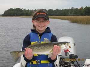 Sophie Hughes, of Sunset Beach, with a speckled trout she hooked on a live shrimp in Calabash Creek while fishing on the "Little Bro Bro."