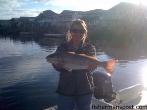 Lindsey Evans, of Ash, NC, with a 24" red drum she hooked on a mud minnow in Shallotte Inlet.