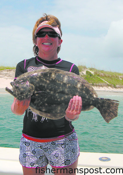 Amy Parker Clem with a 23.5″, 5.6 lb. flounder she hooked on a live pogie in Carolina Beach Inlet while fishing with her husband on the “Parker Jane.”