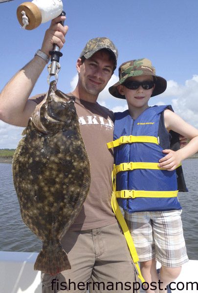 Brent and Oliver Patterson, of Ontario, Canada, with a 7.5 lb. flounder that fell for a new penny Gulp shrimp in Tubbs Inlet while they were fishing with Capt. Patrick Kelly of Capt. Smiley’s Fishing Charters.