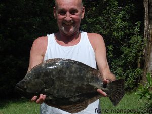 Phil Floyd with a 25" flounder that bit a Gulp shrimp in the ICW near Ocean Isle.
