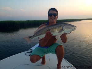 Chris Forehand with a 27.5" red drum he caught and released after it fell for a crab chunk on a jighead in Tubbs Inlet.