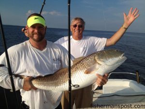 Michael Siengo and Don Lawrence, of Raleigh, NC, with a citation-class red drum that struck a chunk of mullet in the Pamlico Sound.