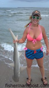 Liza Hernandex, of Johnson City, TN, with a 4' bonnethead shark that bit cut shrimp in the Fort Macon surf.