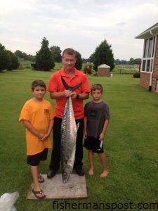 Logan, Heath, and Mason Hewett, of Castle Hayne, NC, with a 38 lb. king mackerel that bit a live menhaden a few miles off Carolina Beach Inlet.