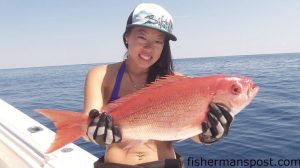 Winnie Cheung, of NY, with a 5 lb. vermillion snapper she hooked while vertical jigging in 120' of water off Wrightsville Beach while she was fishing with Capt. Mike Jackson of Live Line Charters.