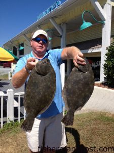 Mickey Cochran with 6.79 and 5 lb. flounder he hooked on live mullet in Tubbs Inlet.