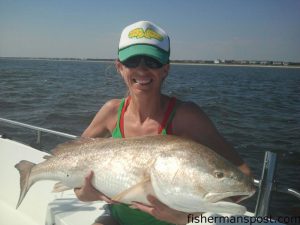 Shea Rushing with a citation red drum that she hooked near Southport while fishing with her husband, Capt. Jamie Rushing of Seagate Charters.