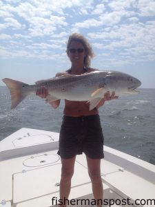Laine Dickson with a bull red drum she hooked on a live mullet in Little River Inlet while she was fishing with her husband, Capt. Mark Dickson of Shallow Minded Inshore Fishing Charters.