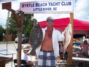 Brian Costello, of team "Fish On Outfitters," with the 5.78 lb. flounder and 4.18 lb. red ddrum that earned the crew Grand Prize and First Place Aggregate in the Bud Grand Slam Tournament, held September 21 out of the Myrtle Beach Yacht Club.