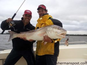 Fisherman's Post Publisher Gary Hurley and Capt. George Beckwith, of Down East Guide Service, with a 49" red drum they caught and released after it fell for a chunk of mullet in 13' of water in the Neuse River near Oriental.