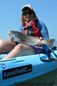 Donna Reid, of PA, with a 22" red drum she hooked in the Pamlico Sound while casting a Gulp swimming mullet under a popping cork with Rob Alderman of Outer Banks Kayak Fishing.
