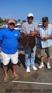 Tony Hayes, Gary Willis, and Doug Shores with the 4.01 and 6.56 lb. flounder that earned the crew the top spot in the Carolina Beach Inshore Challenge. Both fish bit live finger mullet under docks in the ICW near Carolina Beach.