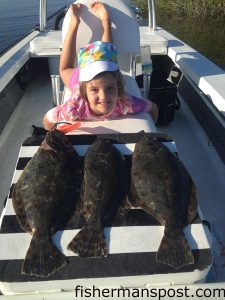 Violet Harris (age 5), of Wilmington, with a trio of flounder she and her father Matthew caught in the lower Cape Fear River on live finger mullet.