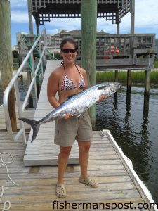 Megan Coggins, of Pleasant Garden, NC, with a stout king mackerel that bit a dead cigar minnow while she was trolling off Wrightsville Beach near the 200/200 with her father on the "Baitfish."
