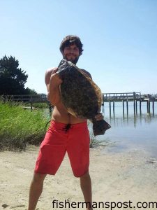 Andrew Hurd with a 7 lb. flounder that struck a live finger mullet near a Wrightsville Beach dock. Weighed in at Tex's Tackle.