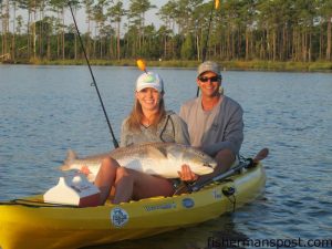 Windy and Peter Overgaard with their first kayak large drum, which fell for a D.O.A. Airhead under a popping cork in the Neuse River near Oriental.