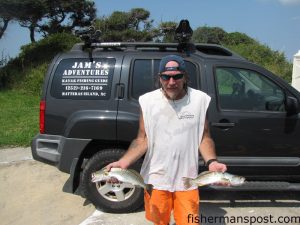 John "JAM" Mortensen,of JAM's Adventures Kayak Fishing, with a speckled and a gray trout he hooked on soft plastic baits while kayak-fishing the Pamlico Sound.