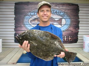 Chris Batsavage, of Morehead City, with a 6.05 lb. flounder that earned him first place in the Chasin' Tails 2nd Annual Flounder Challenge.