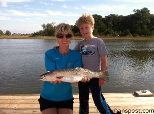 Deanna and Bodie (age 5) Taylor with a 24" speckled trout Bodie hooked in Topsail Inlet on a D.O.A. Shrimp.