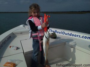 Lauren Hall with a mid-slot red drum she hooked on a live shrimp under a rattling float while fishing near Swansboro with her father, Capt. Robbie Hall of Hall'Em In Charters, and her great uncle Floyd Smallwood.