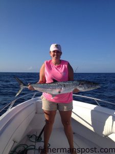 Savannah Norris, of Sneads Ferry, with a king mackerel that bit a live menhaden 12 miles off New River Inlet while she was fishing on the "G's Machine."